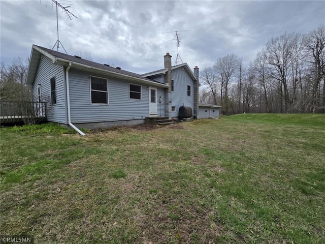 439 270th Ave, Cumberland, WI 54829 - rear view of house featuring a lawn, a wooden deck, and a chimney