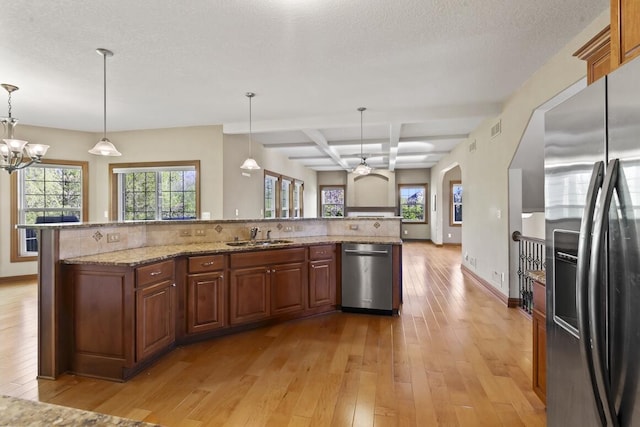 N66W12812 Corryton Ct, Menomonee Falls, WI 53051 - kitchen with stainless steel appliances, light wood-style flooring, a chandelier, open floor plan, and a sink