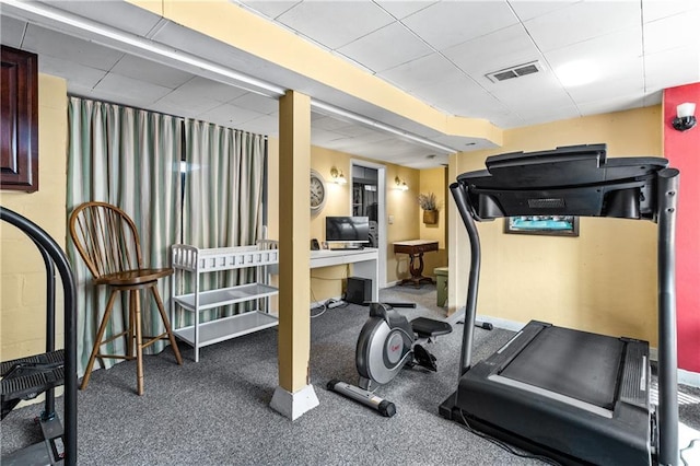 exercise area with visible vents and a drop ceiling
