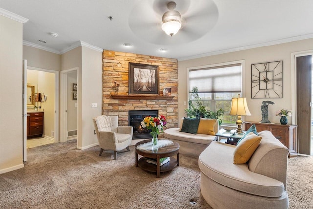 carpeted living area featuring visible vents, ornamental molding, a fireplace, baseboards, and ceiling fan