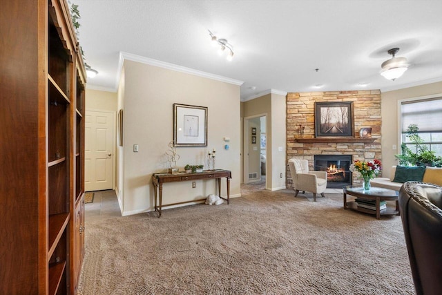 living room with a stone fireplace, ornamental molding, baseboards, and carpet