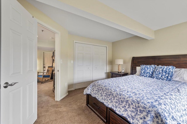 bedroom featuring baseboards, light colored carpet, and a closet