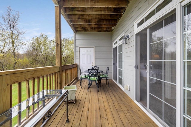 wooden deck featuring outdoor dining space