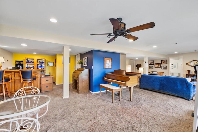 carpeted living area with recessed lighting, ceiling fan, a dry bar, and baseboards