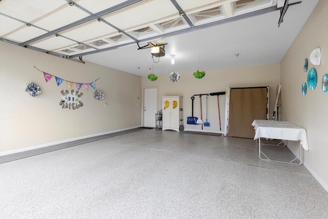 garage with baseboards and a garage door opener