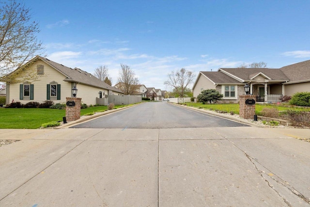 view of road with a residential view and curbs