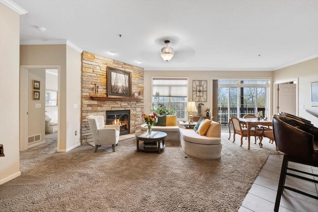 living room with crown molding, visible vents, a fireplace, and light colored carpet