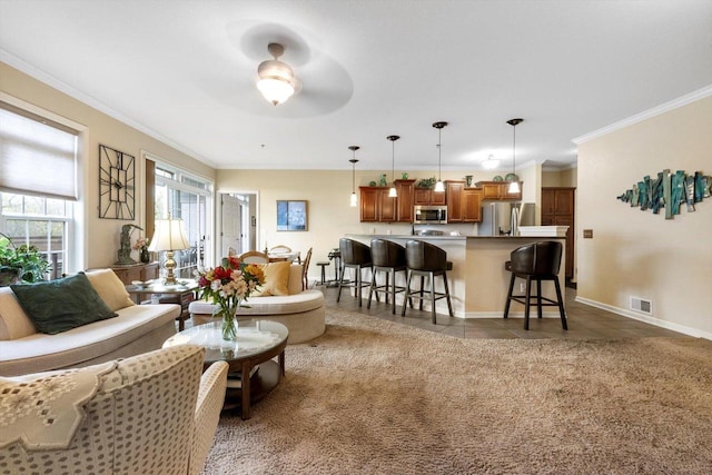 living room with visible vents, ornamental molding, baseboards, ceiling fan, and tile patterned floors
