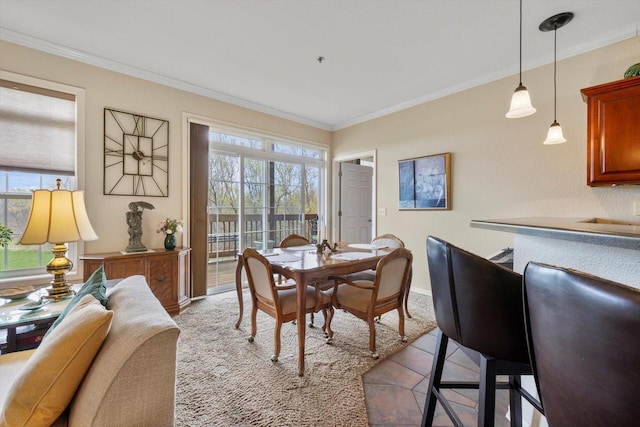 dining room with baseboards and ornamental molding