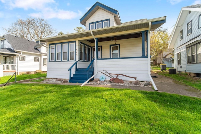 bungalow-style house with a porch, central AC, and a front lawn