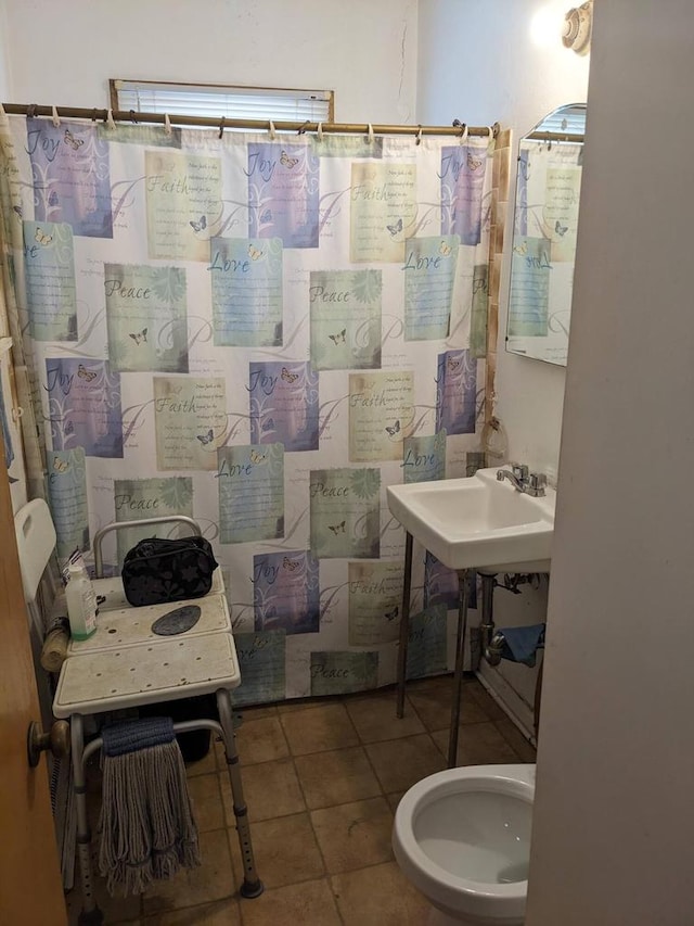 full bathroom with tile patterned floors and a shower with shower curtain