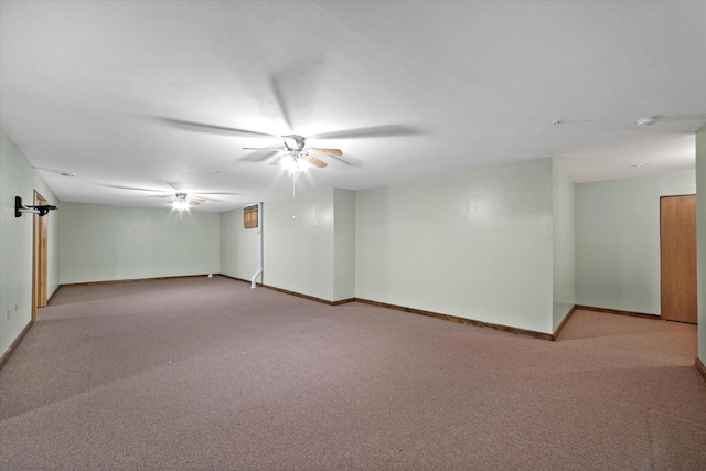 finished below grade area featuring carpet floors, baseboards, and a ceiling fan