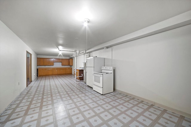finished basement with light floors and freestanding refrigerator