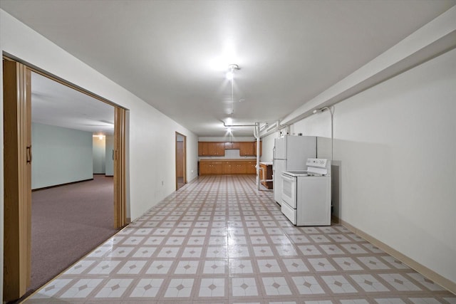 interior space with baseboards and light floors