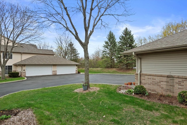 view of yard featuring aphalt driveway