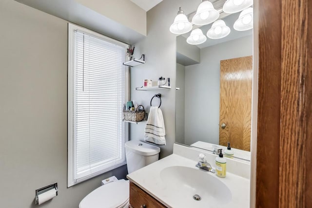 half bath featuring toilet and vanity