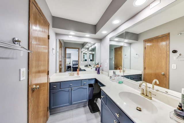 bathroom featuring a sink, recessed lighting, and double vanity