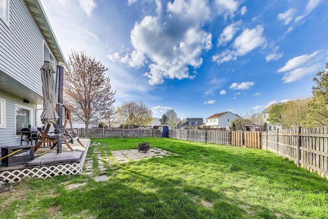 view of yard with a fire pit, a fenced backyard, and a patio area