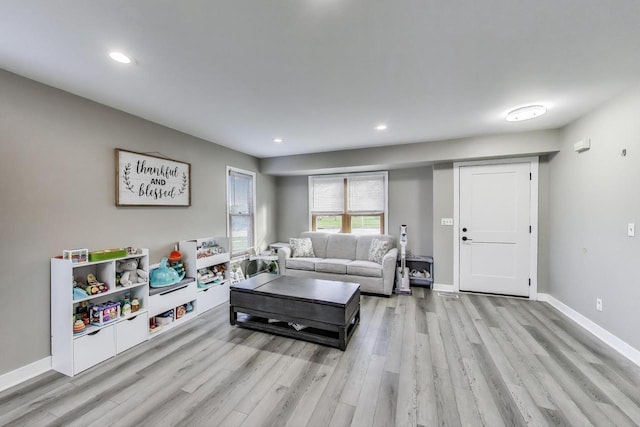 living room featuring recessed lighting, baseboards, and wood finished floors