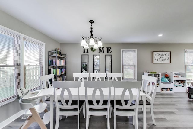 dining room with an inviting chandelier, baseboards, recessed lighting, and wood finished floors