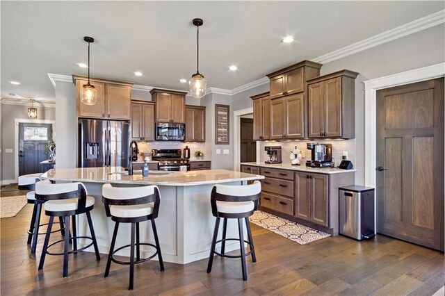 2931 Drier Rd, Eau Claire, WI 54701 - kitchen with appliances with stainless steel finishes, a sink, a kitchen bar, backsplash, and ornamental molding