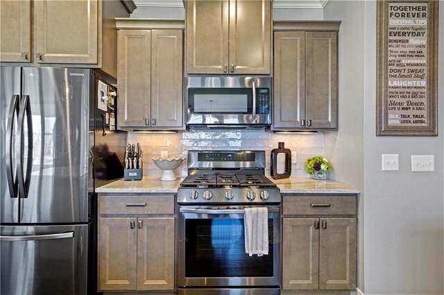 2931 Drier Rd, Eau Claire, WI 54701 - kitchen featuring decorative backsplash, light stone countertops, baseboards, ornamental molding, and stainless steel appliances