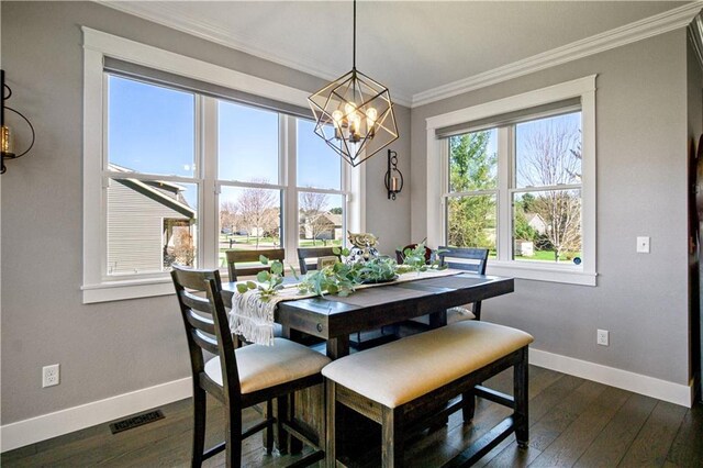 2931 Drier Rd, Eau Claire, WI 54701 - dining space with dark wood-style flooring, visible vents, baseboards, an inviting chandelier, and ornamental molding