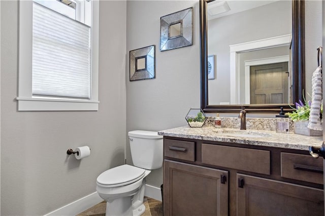 2931 Drier Rd, Eau Claire, WI 54701 - half bathroom featuring a healthy amount of sunlight, baseboards, vanity, and toilet