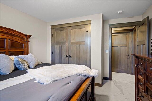 2931 Drier Rd, Eau Claire, WI 54701 - bedroom with baseboards, light colored carpet, and a closet