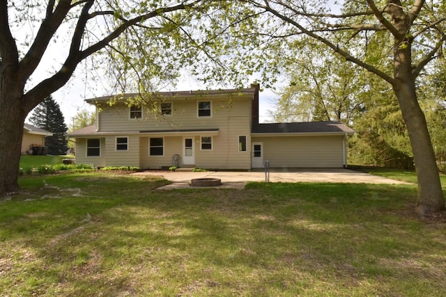 back of house with a patio and a lawn