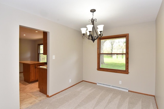 empty room featuring baseboard heating, a chandelier, baseboards, and light colored carpet