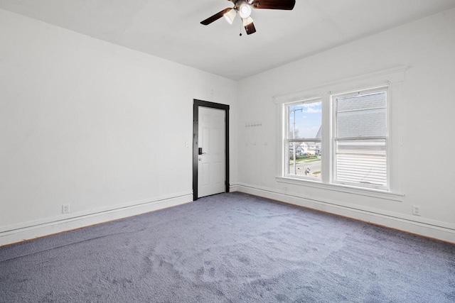 spare room with carpet flooring, a ceiling fan, and baseboards