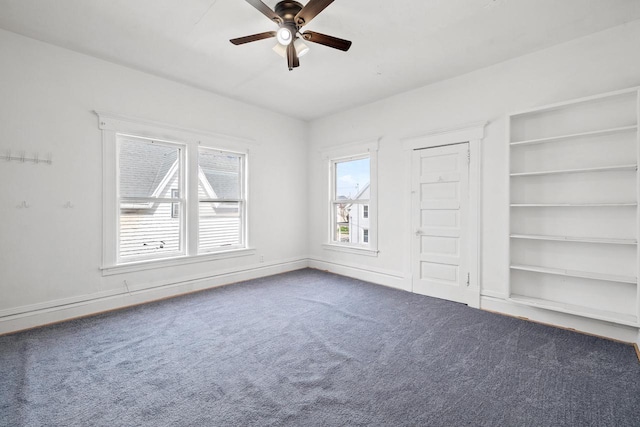 unfurnished bedroom featuring carpet flooring, baseboards, and ceiling fan