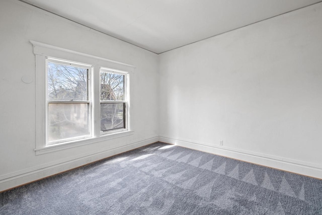 carpeted spare room with baseboards