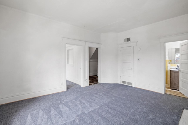 unfurnished bedroom featuring carpet flooring, baseboards, visible vents, and ensuite bathroom