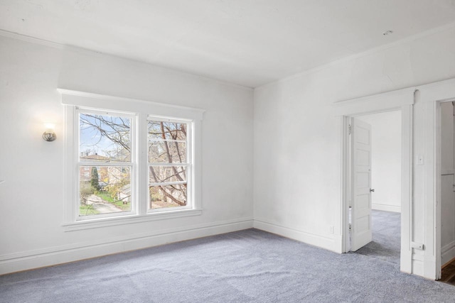 carpeted empty room featuring baseboards and a healthy amount of sunlight
