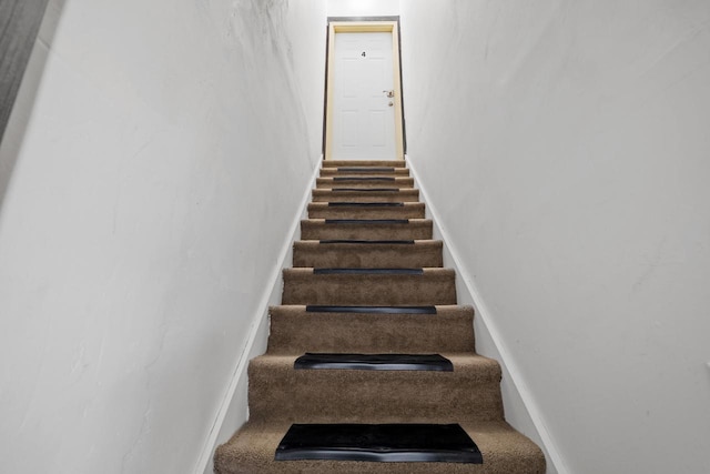 stairs featuring baseboards
