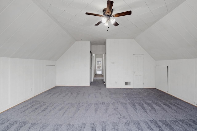 additional living space with ceiling fan, visible vents, carpet, and lofted ceiling