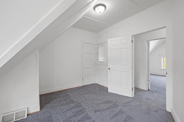 bonus room featuring lofted ceiling, carpet flooring, and visible vents
