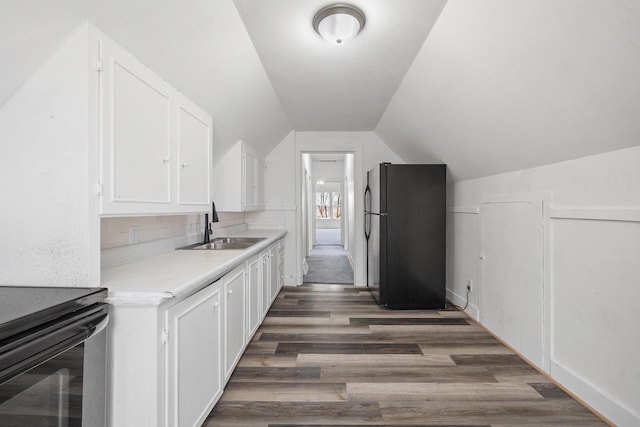 kitchen featuring a sink, white cabinets, black appliances, and wood finished floors