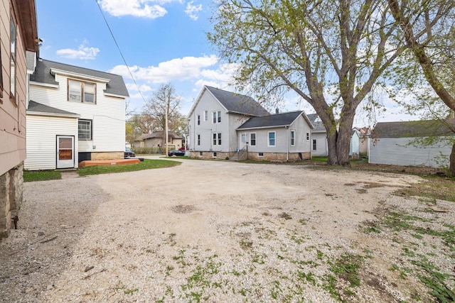 back of property featuring a residential view