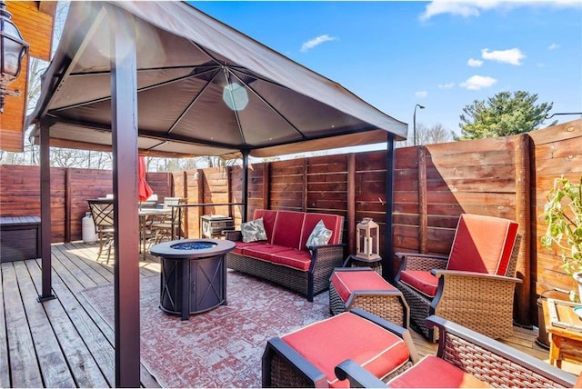 510 State Rd Unit 35, Saint Croix Falls, WI 54024 - wooden terrace with a gazebo, a fenced backyard, and an outdoor living space with a fire pit