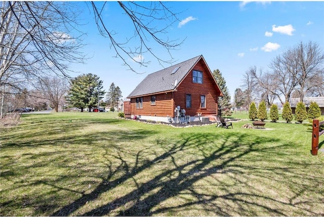 510 State Rd Unit 35, Saint Croix Falls, WI 54024 - view of side of property featuring a lawn, log exterior, and a fire pit
