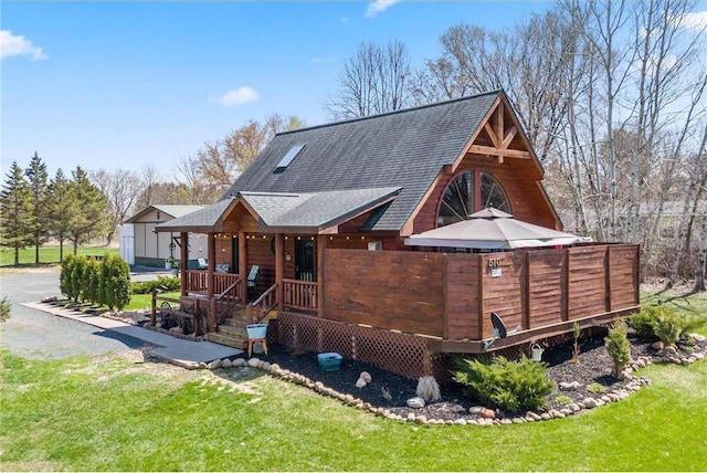 510 State Rd Unit 35, Saint Croix Falls, WI 54024 - rear view of house with covered porch, a shingled roof, and a yard