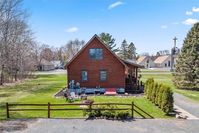 510 State Rd Unit 35, Saint Croix Falls, WI 54024 - rear view of property featuring central AC, fence, and a yard