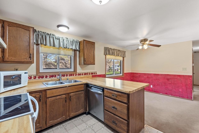 305 Hill Rd, Rosendale, WI 54974 - kitchen with white appliances, a sink, a peninsula, light countertops, and wainscoting