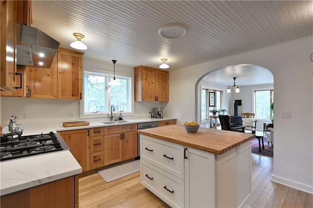 13195 Kavanaugh Rd, Cable, WI 54821 - kitchen with exhaust hood, arched walkways, a sink, light wood finished floors, and wood counters