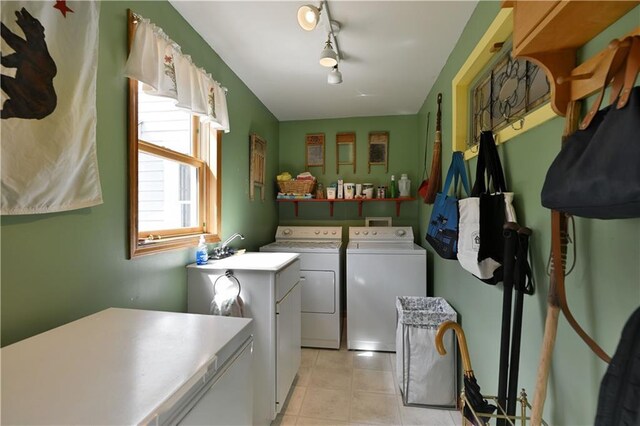 13195 Kavanaugh Rd, Cable, WI 54821 - washroom featuring laundry area, washing machine and clothes dryer, rail lighting, a sink, and light tile patterned floors