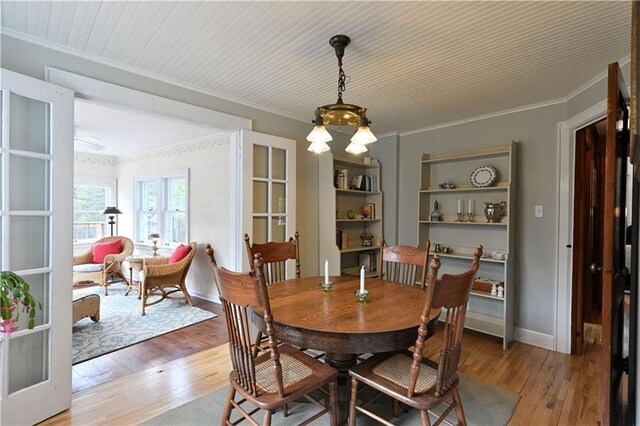 13195 Kavanaugh Rd, Cable, WI 54821 - dining space featuring crown molding, french doors, and light wood-style floors