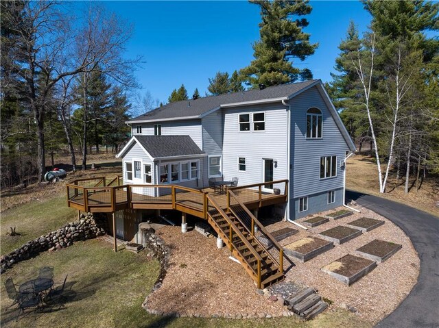 13195 Kavanaugh Rd, Cable, WI 54821 - rear view of property featuring stairway, a deck, a garden, and a lawn